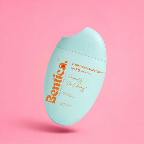 Bentica ultralight face fluid bottle on a pink background
