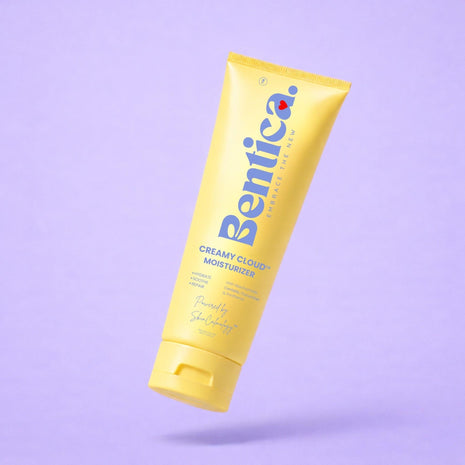 Yellow tube of Bentica Creamy Cloud Moisturizer on a light purple background.
