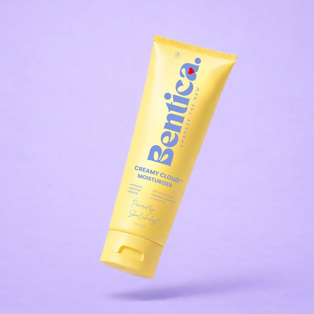 Yellow tube of Bentica Creamy Cloud Moisturizer on a light purple background.
